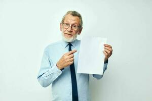 Photo of retired old man in a shirt with a tie copy-space sheet of paper isolated background