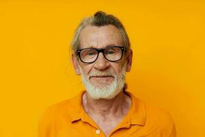 cheerful old man gray beard glasses yellow background photo