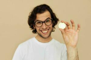 Attractive man in a white T-shirt with Bitcoin cryptocurrency Lifestyle unaltered photo