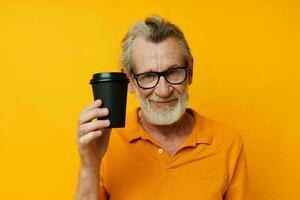 Portrait of happy senior man with black disposable cup isolated background photo