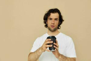 Attractive man with a black glass in a white t-shirt isolated background photo