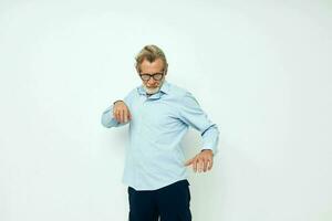 Photo of retired old man in shirt and glasses posing emotions light background