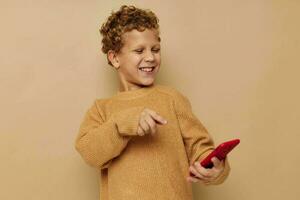 smiling boy in a sweater with a phone in his hands communication photo