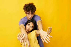 young boy and girl in colorful t-shirts posing friendship fun isolated background unaltered photo