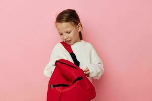 little girl with a red backpack fun isolated background photo