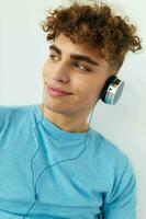 Attractive man in blue t-shirts headphones fashion isolated background photo