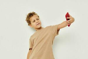 funny curly boy talking on the phone light background photo