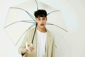 handsome guy transparent umbrella a man in a light jacket isolated background unaltered photo