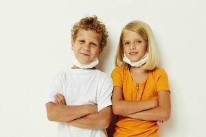 Cute preschool kids in medical mask protection posing grimace isolated background unaltered photo