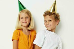 Cute preschool kids in multicolored caps birthday holiday emotion lifestyle unaltered photo