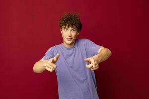 kinky guy in purple t-shirts posing emotions red background unaltered photo