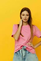 Young woman pink t-shirts and denim shorts posing isolated background photo