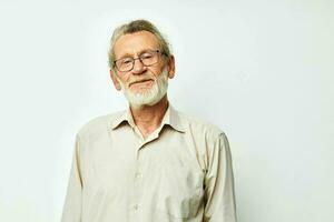 Elderly man posing in studio on gray background and smiling photo