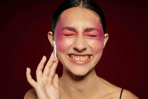 pretty woman bright makeup posing fashion emotions cosmetics pink background unaltered photo