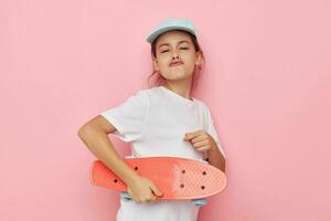 pretty young girl with a skateboard in hand childhood unaltered photo