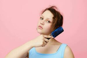 portrait of a woman dislike comb on hair emotion pink color background unaltered photo
