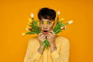 Photo of romantic young boyfriend give flowers wear spectacles yellow shirt Lifestyle unaltered