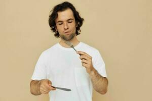 Cheerful man cutlery in hand posing isolated background photo