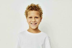 Photo of young boy in a white t-shirt posing fun childhood unaltered