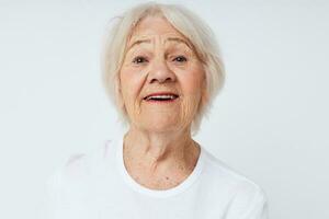 portrait of smiling elderly woman white t-shirt isolated background photo