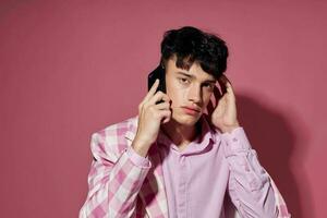 pretty man fashionable talking on the phone pink blazer posing studio Lifestyle unaltered photo