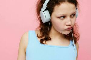 cheerful woman with headphones music posing pink background photo