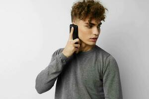 handsome guy with a phone in hand communication isolated background photo