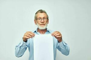 Portrait of happy senior man blank sheet of paper gesture hands smile cropped view photo