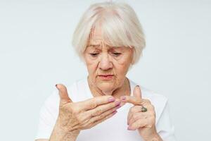 Portrait of an old friendly woman vision problems myopia light background photo