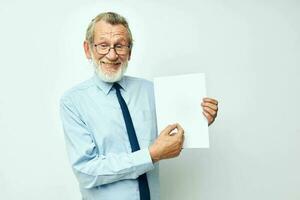 Photo of retired old man in a shirt with a tie copy-space sheet of paper isolated background