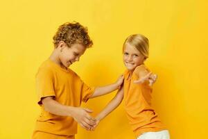 Boy and girl casual wear games fun together posing on colored background photo