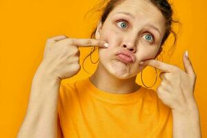 portrait of a young woman gestures with hands grimace emotions isolated backgrounds unaltered photo