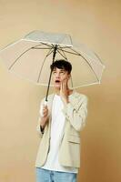 nice guy in a jacket with an open umbrella protection from the rain photo