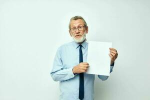 old man holding documents with a sheet of paper light background photo
