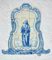 Azulejo tile in Porto, Portugal. Traditional portuguese ceramic decoration blue color. Historic building wall facade. photo