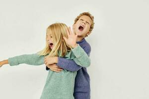 Portrait of cute children gesticulate with their hands together isolated background photo