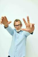 Portrait elderly man in shirt and glasses posing emotions isolated background photo