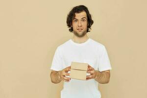 handsome man holding a cardboard small box in his hands photo