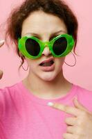 attractive young woman fashion green glasses pink t-shirt decoration posing photo