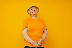 elderly woman in casual t-shirt yellow panama cropped view photo