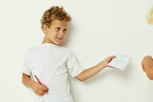 Boy draws with pencil in notebook entertainment studio photo