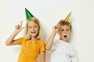 Portrait of cute children with caps on his head holiday entertainment light background photo