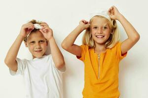 picture of positive boy and girl in a medical mask fun isolated background unaltered photo