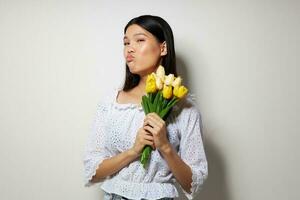 Portrait Asian beautiful young woman romance bouquet of flowers near the face studio model unaltered photo