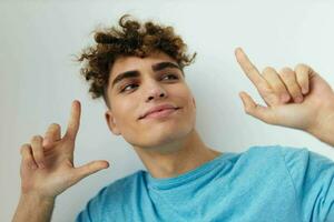 Cheerful guy with curly hair gestures with his hands photo