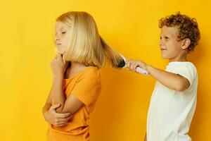 a boy combing a girl's blonde hair photo