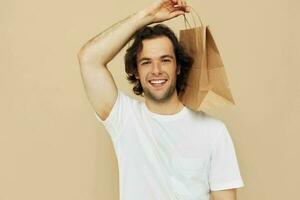 Cheerful man paper bag emotions posing Lifestyle unaltered photo