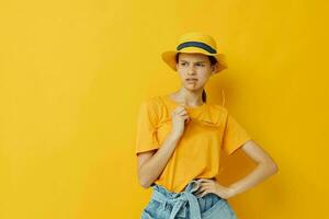 atractivo mujer en un amarillo sombrero juventud estilo casual vestir en Gafas de sol aislado antecedentes foto