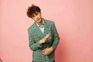 Young curly-haired man checkered blazer elegant style posing fashion isolated background unaltered photo