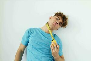 Attractive man blue t-shirt measuring tape posing Lifestyle unaltered photo